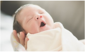 A baby yawning in a blanket

AI-generated content may be incorrect.